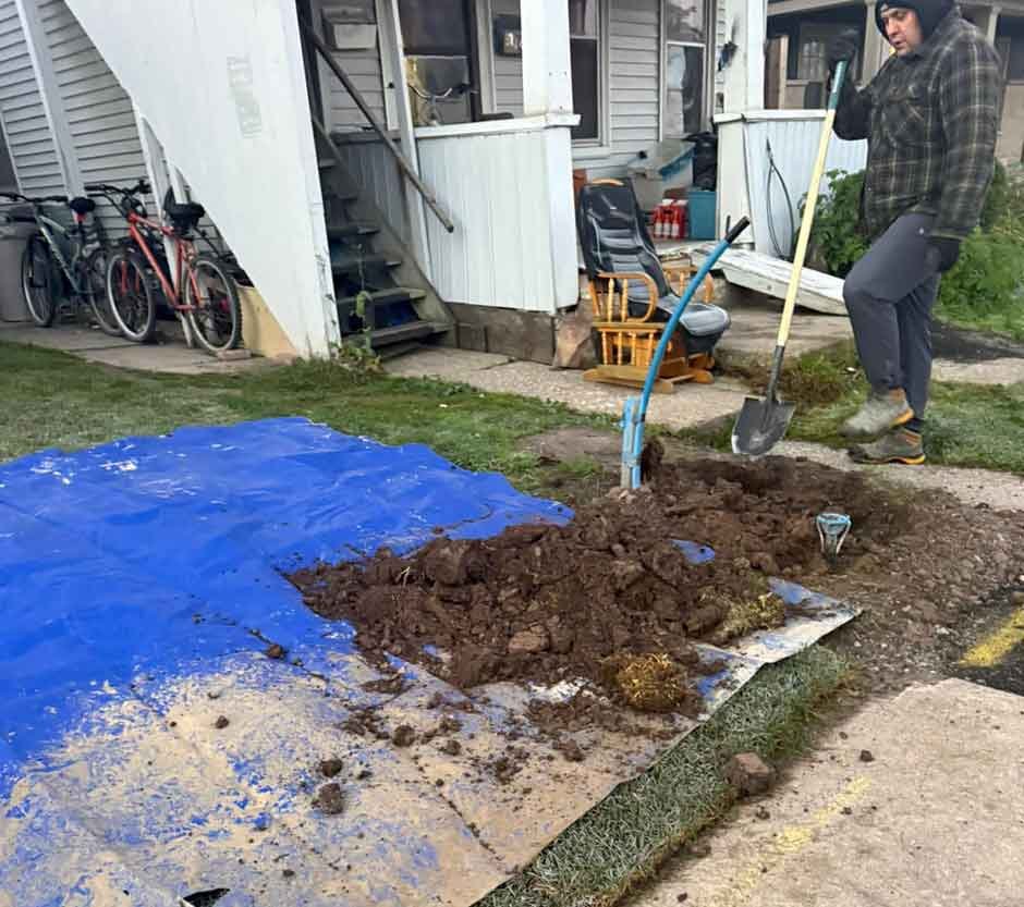 A-man-is-digging-in-the-dirt-of-a-yard